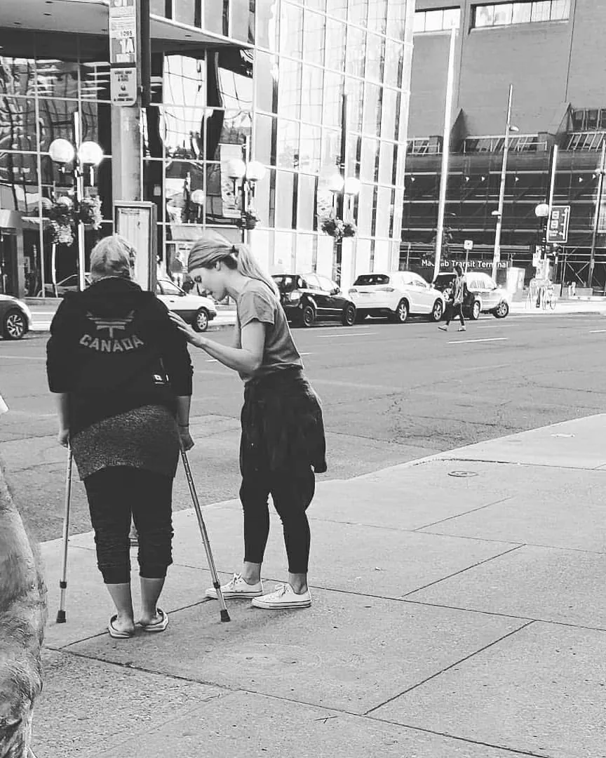 A conversation on a downtown sidewalk during street outreach