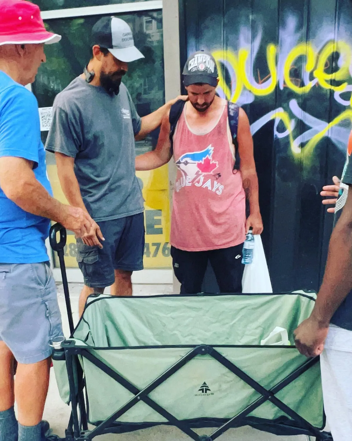Praying with a man on the street in Hamilton