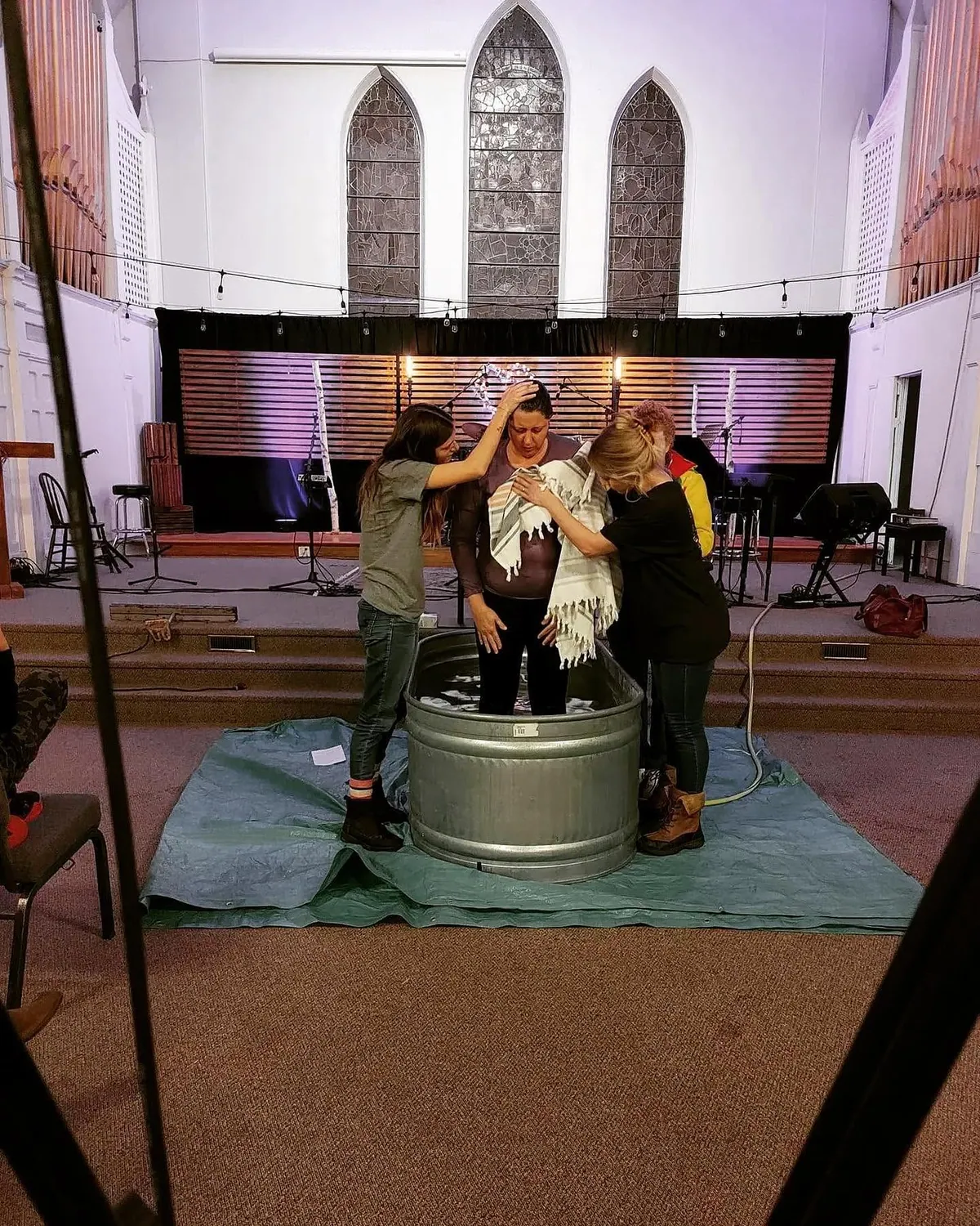 A baptism taking place inside a church sanctuary